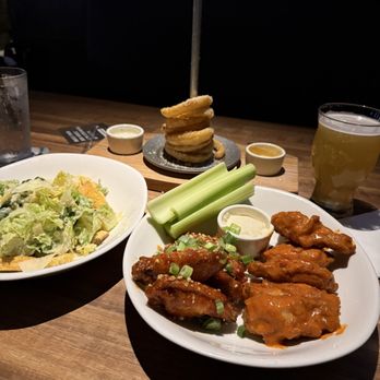 Yard House - 10 Crispy Traditional Wings, Onion Ring Tower, and Traditional Caesar salad. - New American Near Me - Atlanta, Georgia Yard House - 10 Crispy Traditional Wings, Onion Ring Tower, and Traditional Caesar salad. - New American Near Me - Atlanta, Georgia