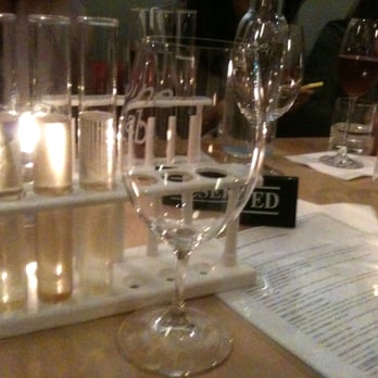 Wine Lab - Test tube wine flights! Pay attention to the emanating candle in beakers through the test tube. - Wine Bars Near Me - Costa Mesa, California