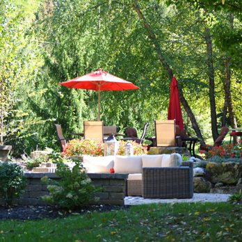 Plant Studio Landscape - a patio with furniture and an umbrella - Snow Removal Near Me - Muncie, Indiana