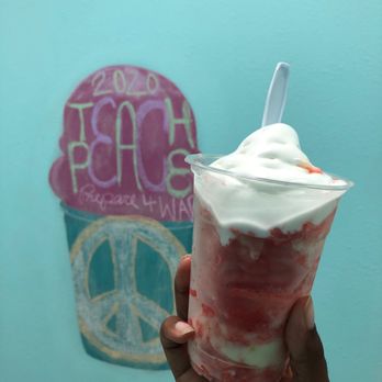 Purdees Tropical Flavored Ice - a hand holding a cup of ice cream - Ice Cream & Frozen Yogurt Near Me - Palm Coast, Florida Purdees Tropical Flavored Ice - a hand holding a cup of ice cream - Ice Cream & Frozen Yogurt Near Me - Palm Coast, Florida