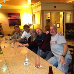 a group of people sitting at a bar
