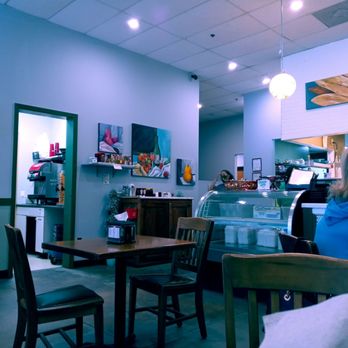 Secret Garden Cafe - a woman sitting at a table - Cafes Near Me - Jacksonville, Florida