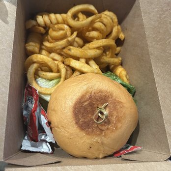 Swine & Sons - came like this. I really dont want dirty packets of ketchup all over n touching my burger. They should be put outside in the bag itself - Burgers Near Me - Las Vegas, Nevada