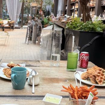 NOMO Kitchen - Chicken and waffles and eggs Benedict, sweet potato fries and OJ - New American Near Me - New York, New York