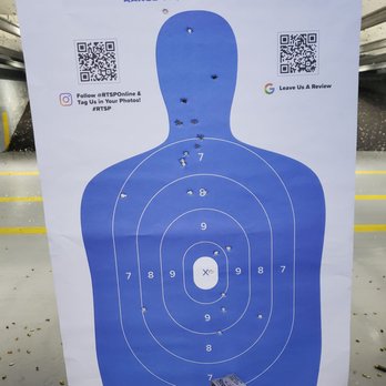 RTSP - Target Practice - A paper shooting target with bullet holes, featuring a human silhouette and concentric scoring rings, is displayed at an indoor shooting range. - Gun/Rifle Ranges Near Me - Randolph, New Jersey