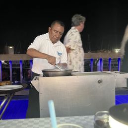 The chef cooking the shrimp in front of us The chef cooking the shrimp in front of us