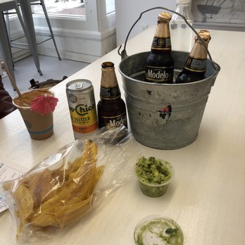 Frita Batidos - Plantain chips, avocado spread, modelo negra, and toppo chico hard seltzer. - Cuban Near Me - Ann Arbor, Michigan