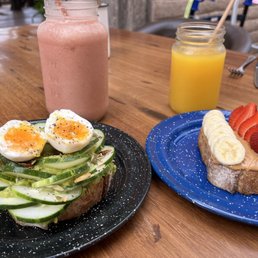 Avocado toast, peanut butter and banana and strawberry toast, orange juice and strawberry banana smoothie.