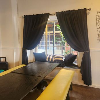 Jazzy’s Eats and Treats - Black table with yellowish bench, which brings out the black and beautiful curtains that's open to bring in some . - Breakfast & Brunch Near Me - Montgomery, Alabama Jazzy’s Eats and Treats - Black table with yellowish bench, which brings out the black and beautiful curtains that's open to bring in some . - Breakfast & Brunch Near Me - Montgomery, Alabama