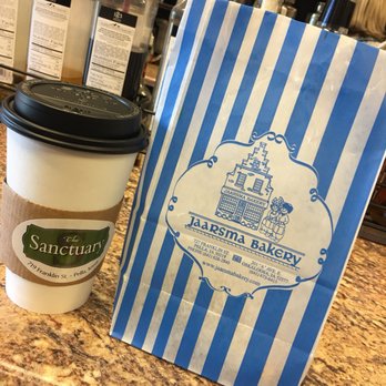 The Sanctuary - a cup of coffee and a paper bag - Coffee & Tea Near Me - Pella, Iowa The Sanctuary - a cup of coffee and a paper bag - Coffee & Tea Near Me - Pella, Iowa