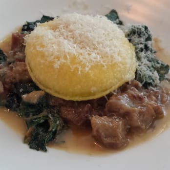 ABC Kitchen - the raviolo. ricotta cheese & egg yolk enveloped in a homemade pasta shell :) on top of sauteed kale & pulled pork - Breakfast & Brunch Near Me - New York, New York