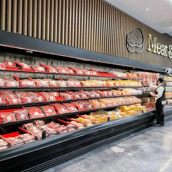 Hatzlacha Supermarket - a man standing in front of a display of meat - International Grocery Near Me - Brooklyn, New York Hatzlacha Supermarket - a man standing in front of a display of meat - International Grocery Near Me - Brooklyn, New York
