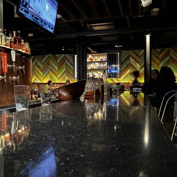 Eureka! - a bar with people sitting at the bar - American Near Me - Austin, Texas