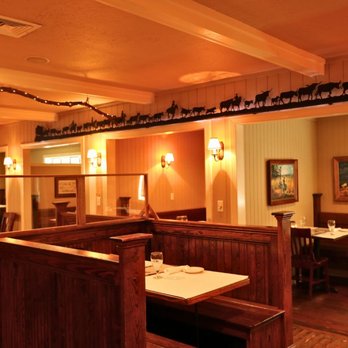 JK's Restaurant - JK's dining room offers a cozy, western-inspired atmosphere with rich wooden booths, soft wall lighting, and art that capture... - Steakhouses Near Me - Kill Devil Hills, North Carolina JK's Restaurant - JK's dining room offers a cozy, western-inspired atmosphere with rich wooden booths, soft wall lighting, and art that capture... - Steakhouses Near Me - Kill Devil Hills, North Carolina