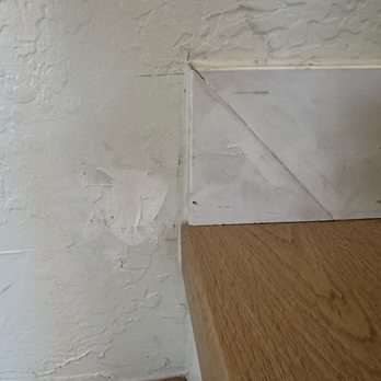 Floor One - Damage to the wall they did. How they left the baseboard - Flooring Near Me - Mesa, Arizona