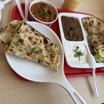 Bikanervala - Garlic naan left mix veggies center lentil and yogurt with onion kulcha at furthest right - Indian Near Me - Diamond Bar, California