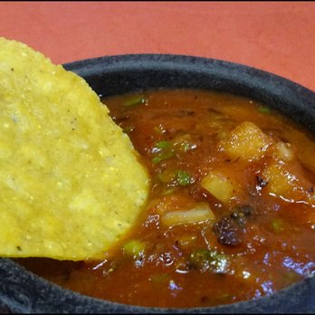 Los Zarapes Mexican Restaurant - I dip a fresh corn tortilla chip into the delicious, robust, chunky salsa. - Mexican Near Me - Granite Bay, California
