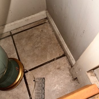 Myrtle Beach Vacation Stations - Beside full bed. Moved the lamp to see a comb covered in hair and floors that have never been cleaned - Vacation Rental Agents Near Me - Little River, South Carolina