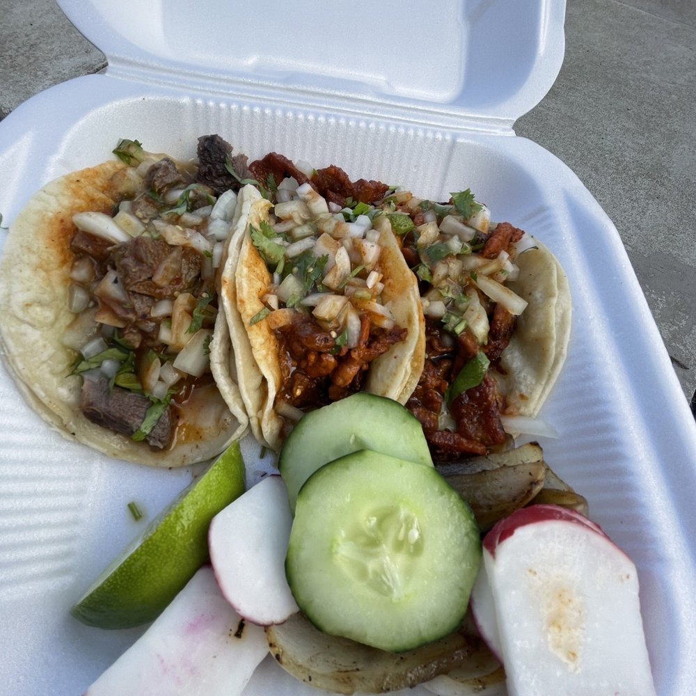 a plate of tacos and a cucumber a plate of tacos and a cucumber