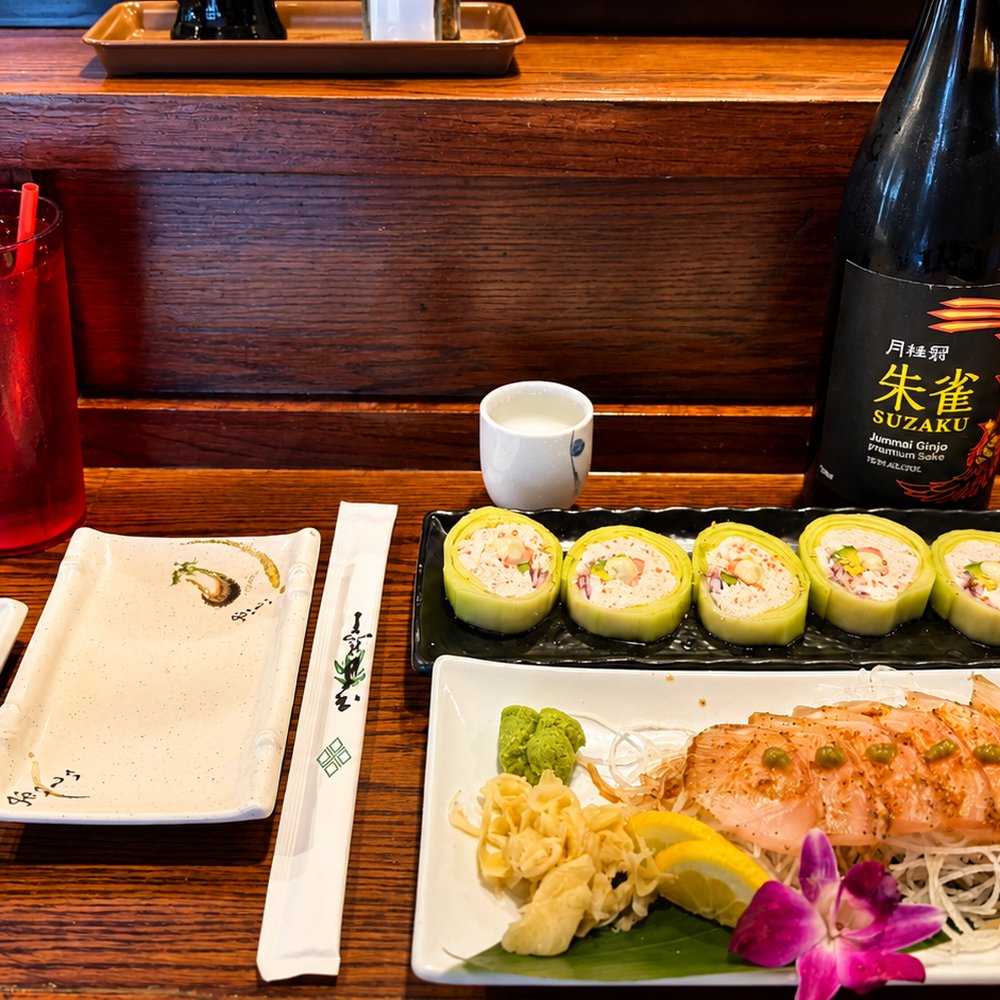 KANZI - Kanzi place setting with a bottle of sake from the store nearby - Sushi Bars Near Me - The Colony, Texas