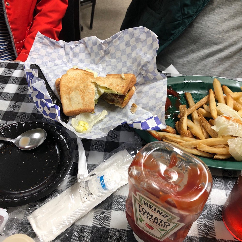 a sandwich and fries on a table a sandwich and fries on a table