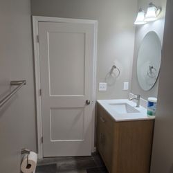 BC Finishing Solutions - Basement bathroom renovation including painting, trim work, floor installation, vanity and accessories