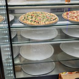 pizzas in a display case pizzas in a display case