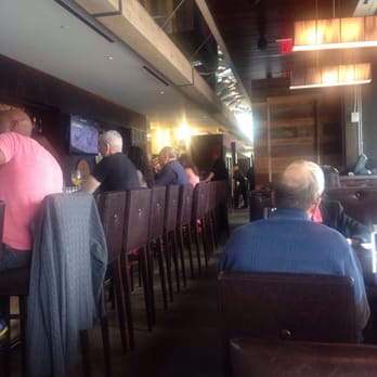 Epic SmokeHouse - Beautiful bar area with high back chairs. - Steakhouses Near Me - Arlington, Virginia Epic SmokeHouse - Beautiful bar area with high back chairs. - Steakhouses Near Me - Arlington, Virginia