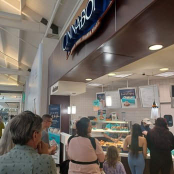 Cinnabon - a crowd of people standing in line at the counter - Bakeries Near Me - Escondido, California