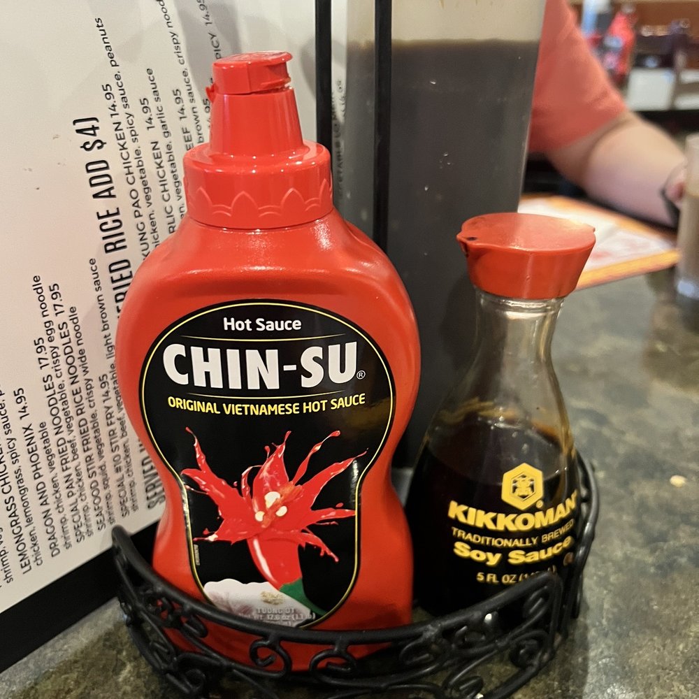 Asian Palace Pho 99 - a bottle of chili sauce and a pair of scissors - Vietnamese Near Me - Grand Rapids, Michigan Asian Palace Pho 99 - a bottle of chili sauce and a pair of scissors - Vietnamese Near Me - Grand Rapids, Michigan