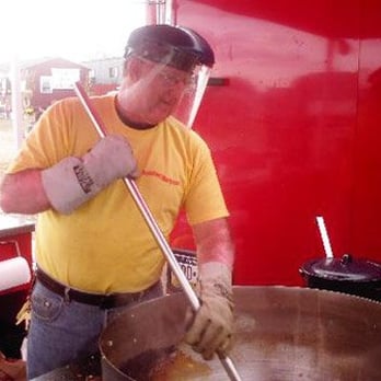 Best Darn Kettlecorn - a man in a yellow shirt stirring a pot of food - Farmers Market Near Me - Bristol, Pennsylvania