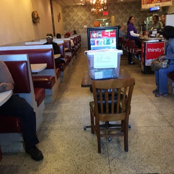 Aquarius Restaurant - a woman sitting at a table with a laptop - American Near Me - Upper Darby, Pennsylvania Aquarius Restaurant - a woman sitting at a table with a laptop - American Near Me - Upper Darby, Pennsylvania