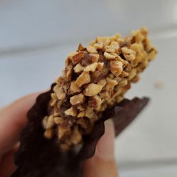 a hand holding a chocolate bar a hand holding a chocolate bar