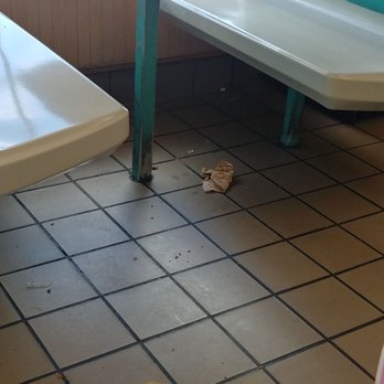 KFC - Filth and trash under one of the tables - Chicken Wings Near Me - Rogers, Arkansas