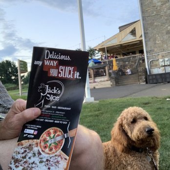 Jack's Slice - a man sitting in the grass with his dog - Pizza Near Me - Allentown, Pennsylvania
