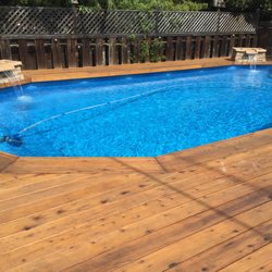 16' x 32' Doughboy pool with redwood decking and waterfall planters.