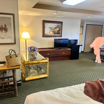 AmericInn by Wyndham Cody - The living area of the triple queen. - Hotels Near Me - Cody, Wyoming