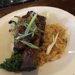Korean short ribs served over broccolini with kimchi rice.
