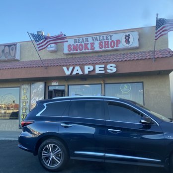 Bear Valley Smoke Shop - a car parked in front of the store - Tobacco Shops Near Me - Hesperia, California