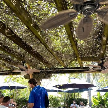 O. C. White's Restaurant - Server on patio with outdoor fan. - Seafood Near Me - St Augustine, Florida