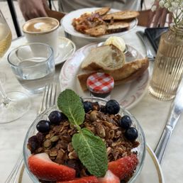 Yogurt parfait, baguette with jam and butter, eggs bacon and toast Yogurt parfait, baguette with jam and butter, eggs bacon and toast