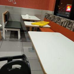 McDonald's - Wet floor signs belong on the floor most of the time in the restroom. They should never go on top of a table.