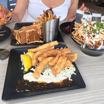 Down the Hatch Maui - Photo Left: Lava shrimps,  Photo Right: Mermaid fries Center Front: Fried Calamari Center Back: Lobster & Crab Sandwich w fries - Seafood Near Me - Lahaina, Hawaii