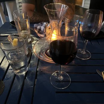 Parrott's on 11th - a man sitting at a table with glasses of wine - Seafood Near Me - Morehead City, North Carolina Parrott's on 11th - a man sitting at a table with glasses of wine - Seafood Near Me - Morehead City, North Carolina