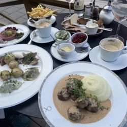 Bakfickan - Swedish meatballs with potatoes. Lingonberries and pickled cucumbers, pickled herring and beef tartare with French fries.