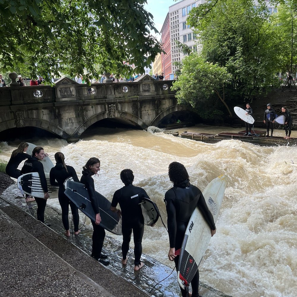 Eisbach-Welle - Line of surfers - Landmarks & Historical Buildings Near Me - Munich, BY Eisbach-Welle - Line of surfers - Landmarks & Historical Buildings Near Me - Munich, BY