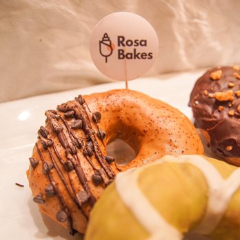 Rosa Bakes - a variety of doughnuts on display - Cupcakes Near Me