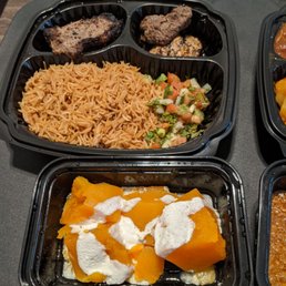 Photo of The Helmand - Baltimore, MD, United States. Front: kaddo borwani (pumpkin appetizer) Back: mix of lamb loin chop, beef kebob, chicken kebab and lamb kebab