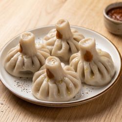 Hand-twisted dumplings filled with juicy seasoned meat and broth, boiled and served hot. A Georgian classic, best eaten by hand