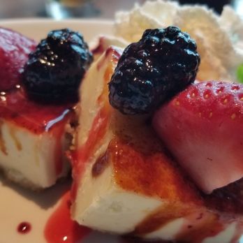 Firebirds Wood Fired Grill - Creme Brulée Cheesecake Bruléed to order, fresh fruit, raspberry coulis. - American Near Me - Grapevine, Texas Firebirds Wood Fired Grill - Creme Brulée Cheesecake Bruléed to order, fresh fruit, raspberry coulis. - American Near Me - Grapevine, Texas